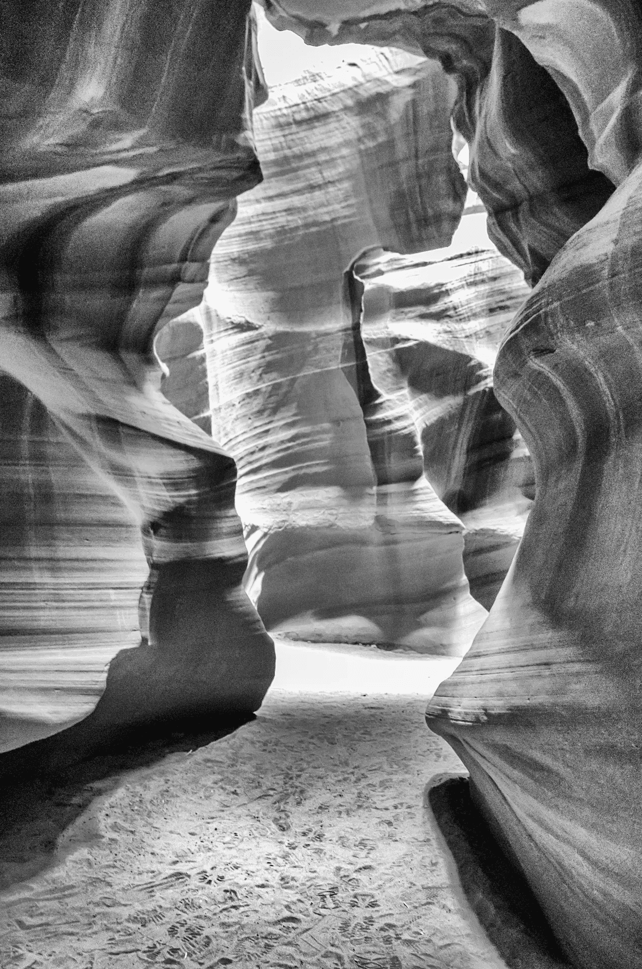 Black and white view of Antelope Canyon's sculpted sandstone walls in Arizona.