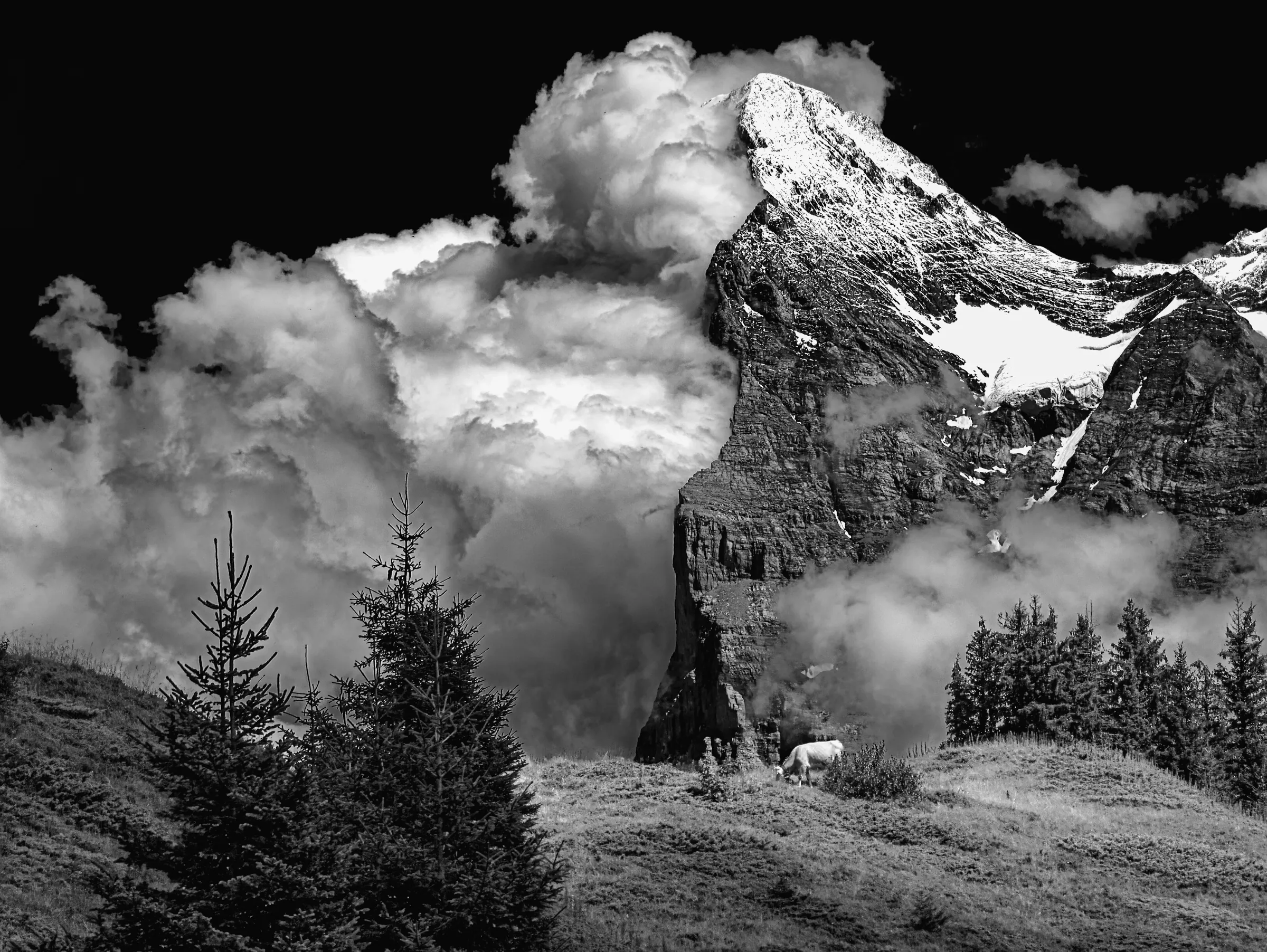 Dramatic black and white landscape photograph of the Eiger mountain in the Swiss Alps.