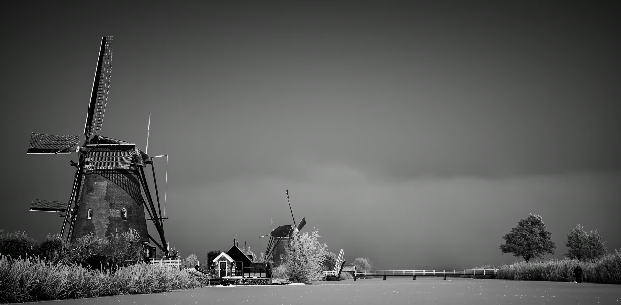Windmills in Mist in Kinderdijk in monochrome.