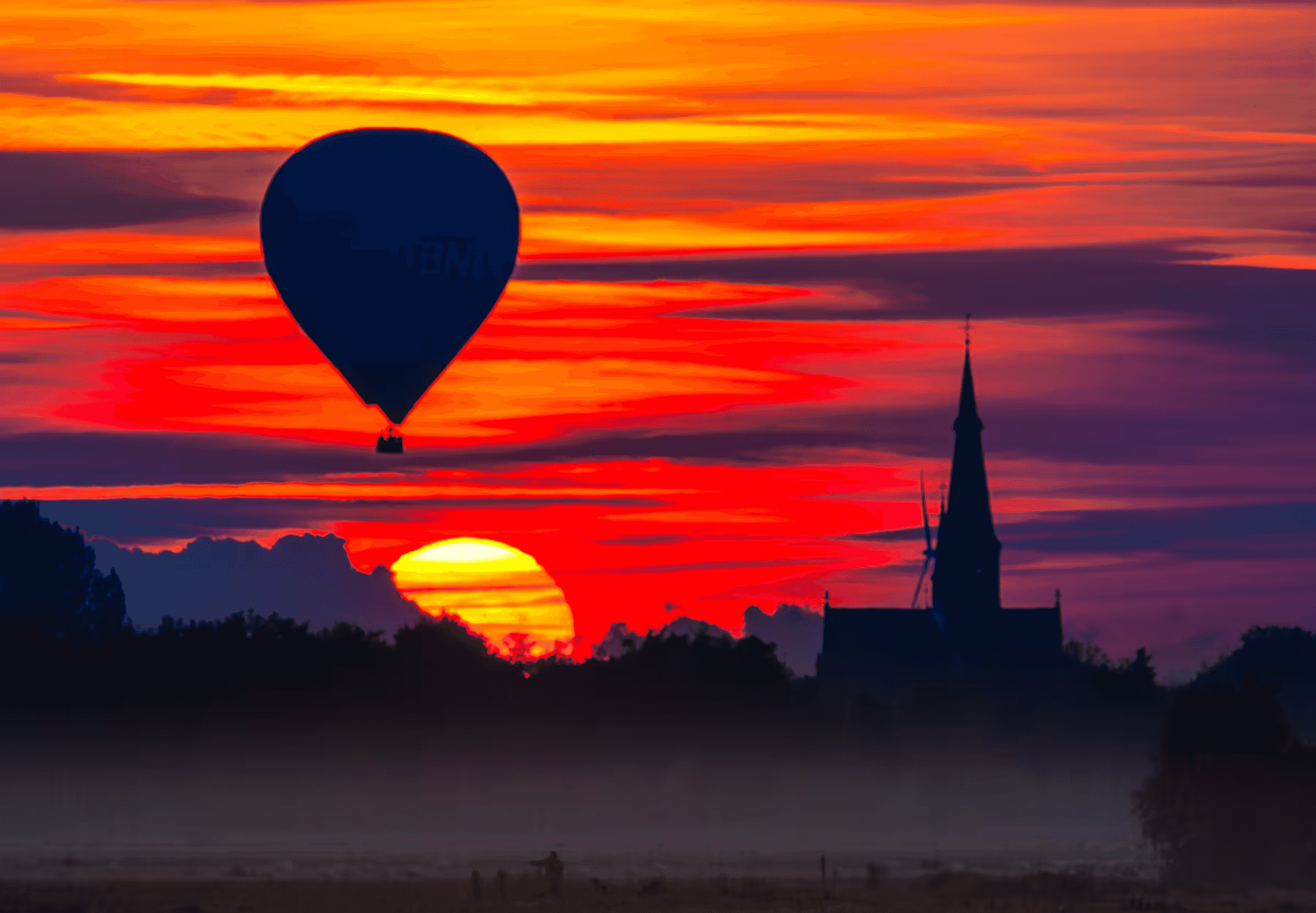 Landscape photograph of a hot air balloon silhouetted against a vibrant sunset in North Brabant, Netherlands.