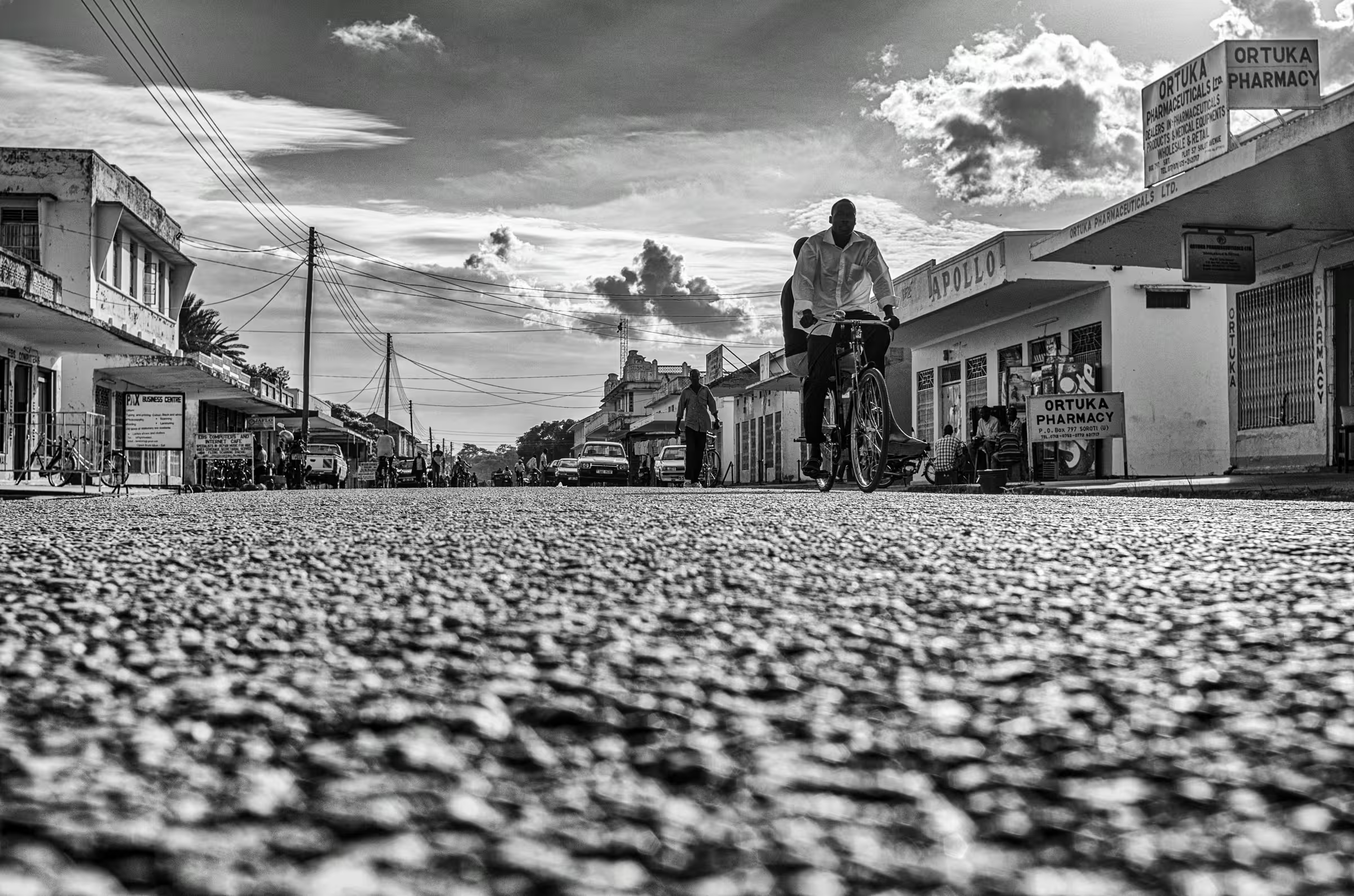 Black and white street scene photograph in Ortuka, Northern Uganda.