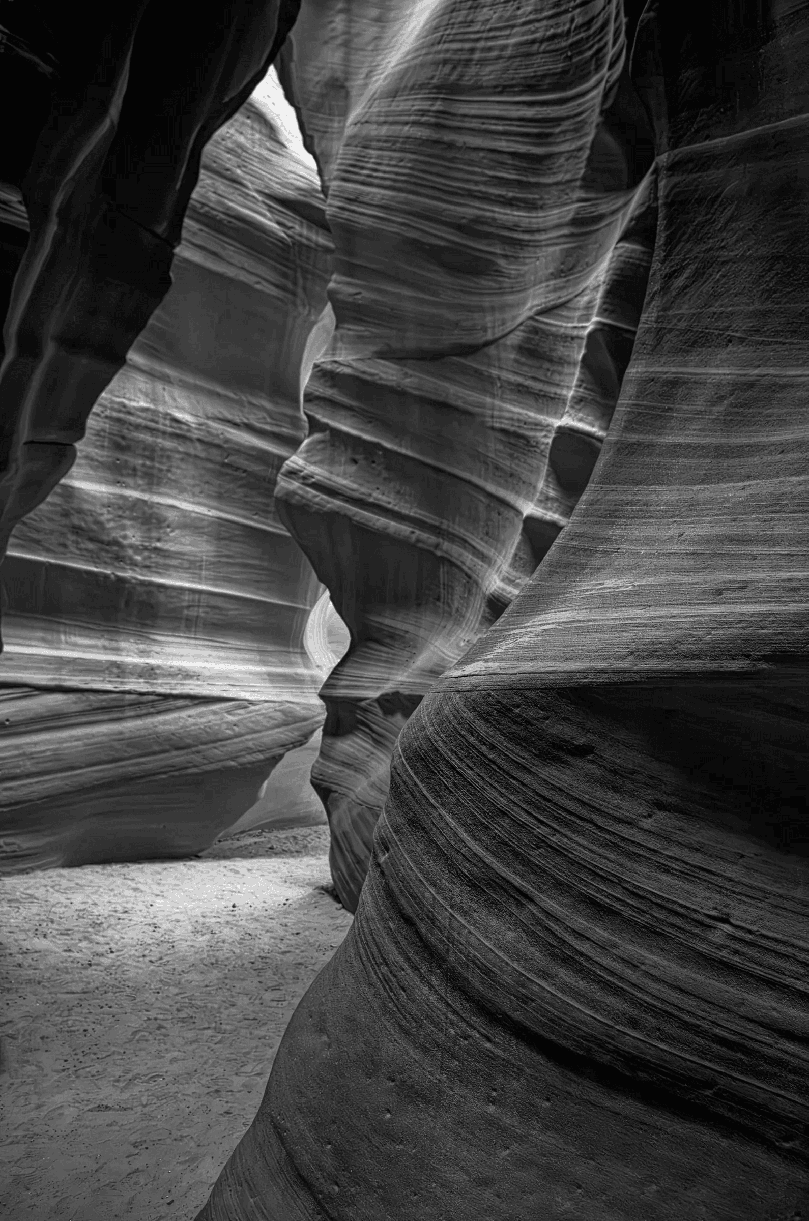 Click to view in fullscreen Monochrome view through the layered, curving sandstone walls of Antelope Canyon in Arizona.