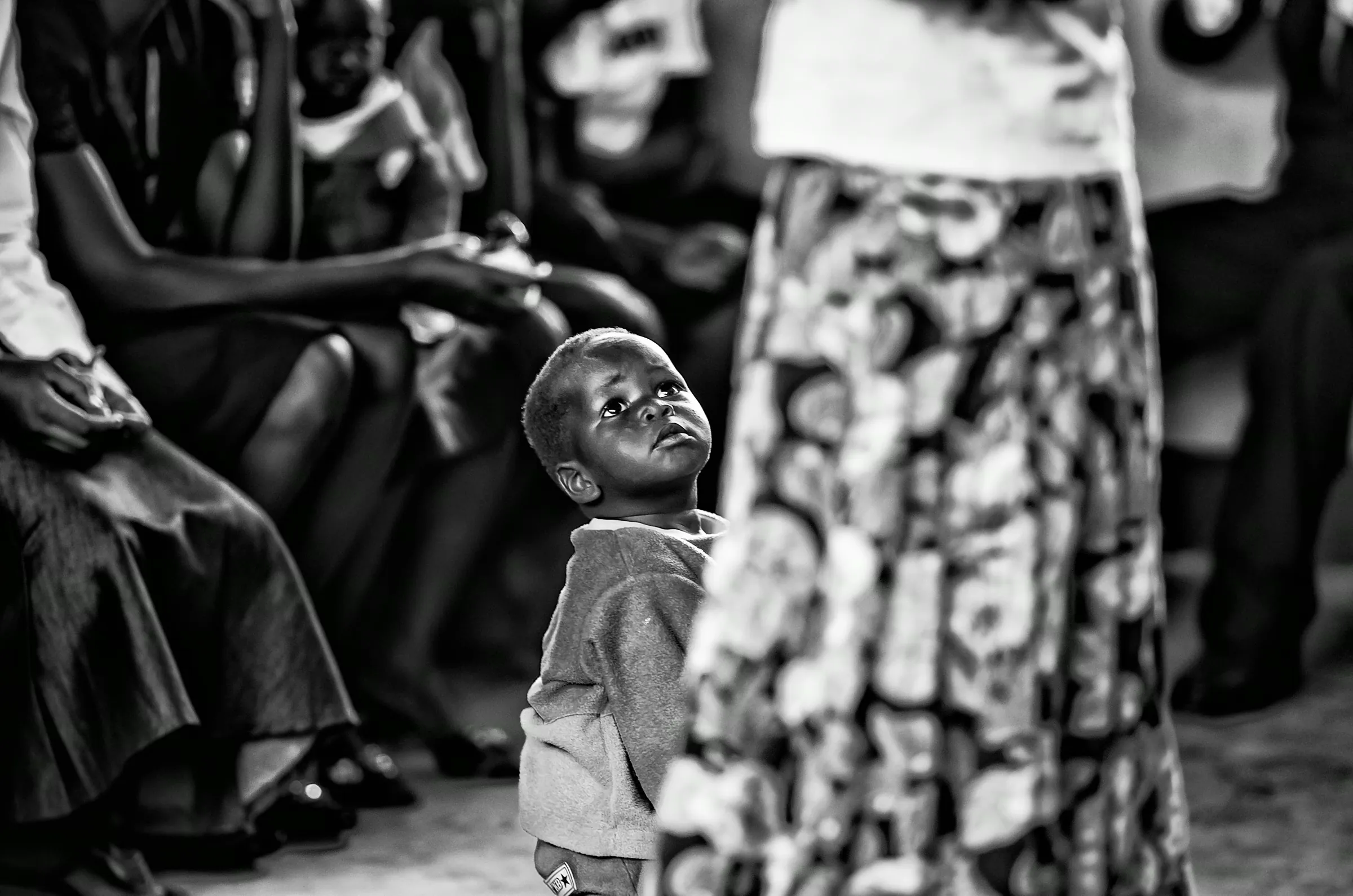 Child Looking Up in a quiet portrait in Uganda in monochrome.