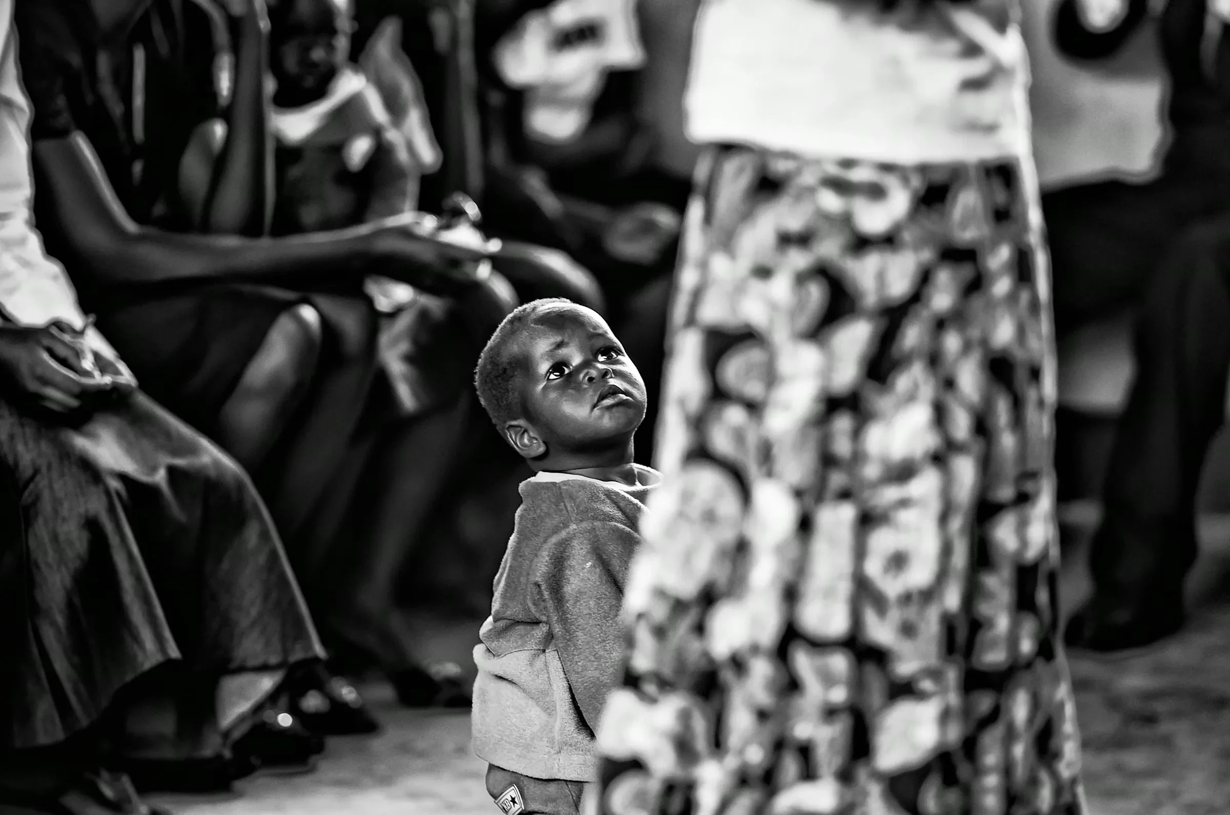 Child Looking Up in a quiet portrait in Uganda in monochrome.